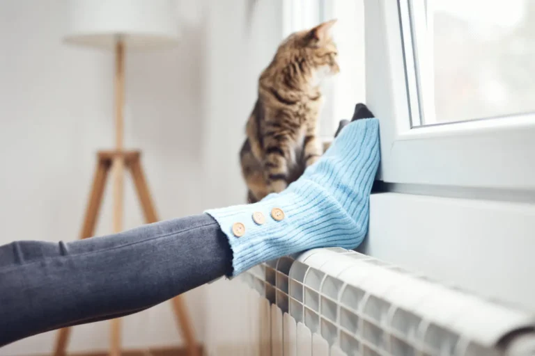 woman resting feet on radiator