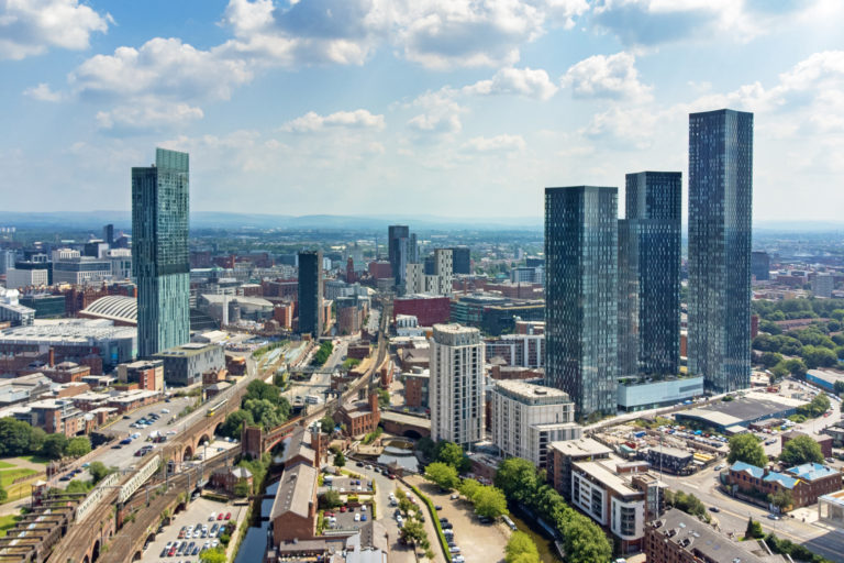 An aerial view of the Manchester skyline from Deansgate, showing multiple high-rise properties landlords north west