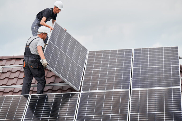 workers installing solar panels